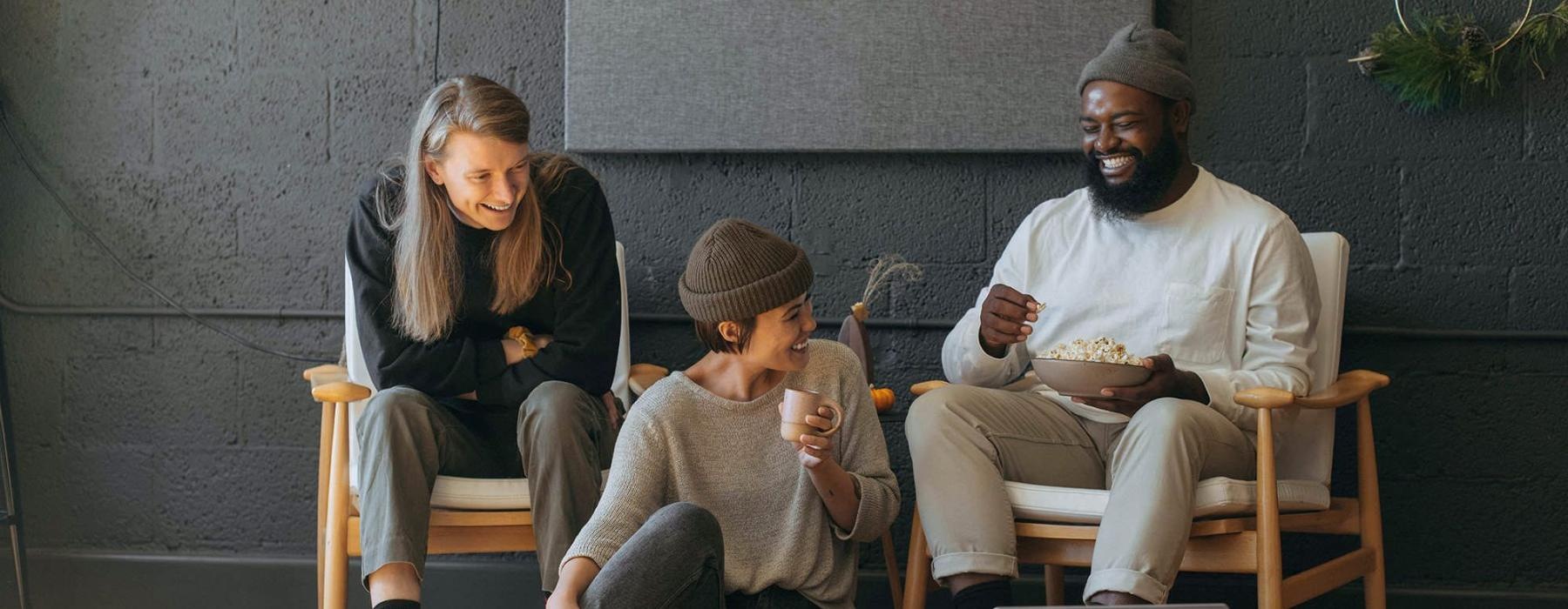 friends sit together around an open laptop